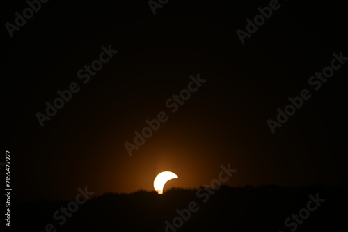 Partial solar eclipse visible in the daytime sky, with the Moon covering part of the Sun and creating a dramatic celestial phenomenon. Czech epublic, Silesia, Hnevosice, 12-September 2026