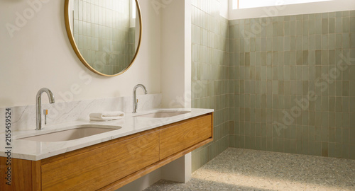 Modern mid century washroom vanity featuring natural wood cabinetry and elegant sage green tiled shower wall backdrop with displays contemporary double white marble countertops