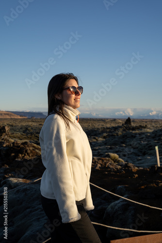 Young Woman Smiling and Enjoying Sunset in Icelandic Volcanic Landscape