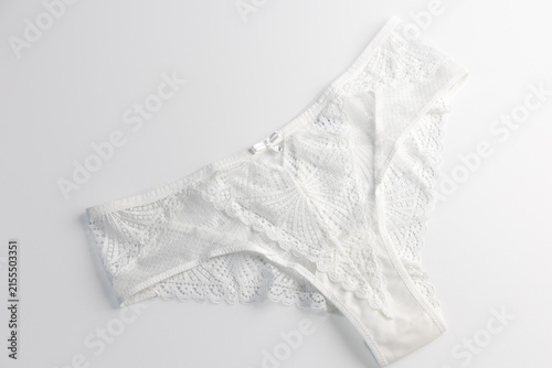 Bild auf Leinwand White lace womens panties on soft fabric bridal underwear concept