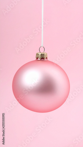 Large Pink Bauble Hanging Against Pink Wall
