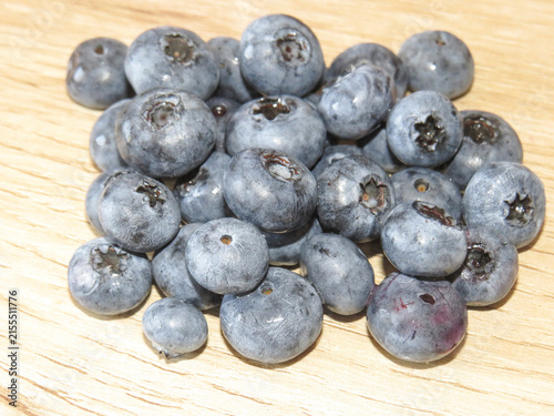 A pile of blueberries on a wooden background
