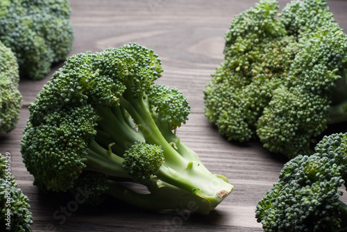 Fresh raw broccoli on wooden table