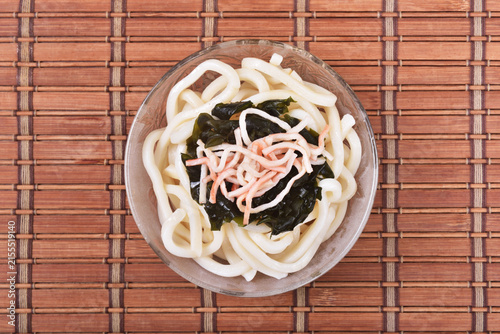 Cold udon noodles in glass bowl   