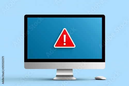 A computer screen shows a warning sign in red