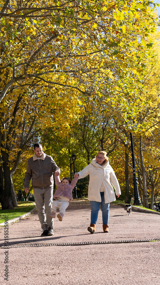 Fototapeta premium Family walking having fun in autumn park