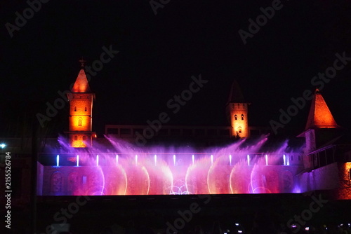 Colored musical fountains in the city park. Night time.