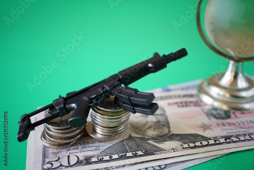 Dollar bills with toy guns and coins.