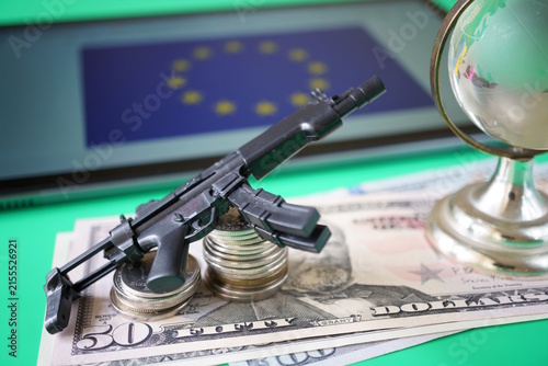 Dollar bills with weapons and the flag of the European Union.