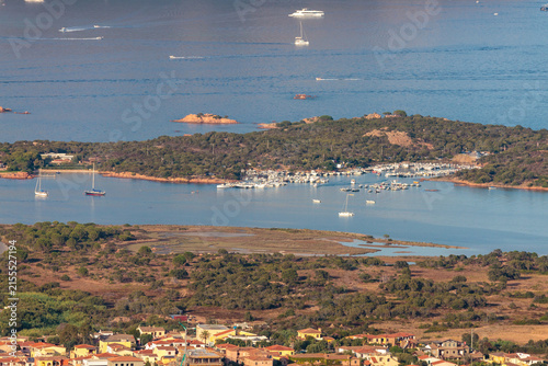 aerial full view of Cala Finanza harbour, jetty, Porto San Paolo, with protected natural area destined to construction site