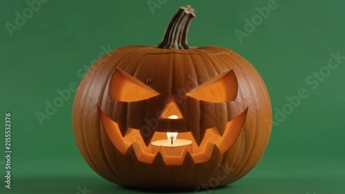 Halloween Jack-o'-Lantern on Green Screen Background, Spooky Carved Pumpkin with Candle Inside, Eerie Mood for Holiday Celebrations, Static Video
