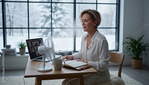 Woman Using Fan to Manage Hot Flash During Menopause at Home