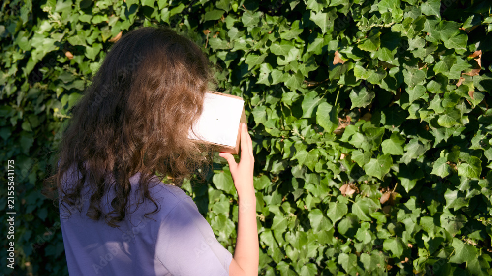 Fototapeta premium Child Viewing Solar Eclipse with Pinhole