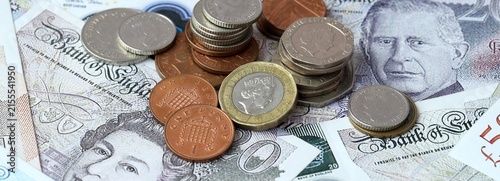British pound money banknotes and coins on table. United Kingdom cash bills of GBP currency
