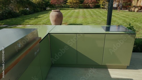 Modern green outdoor kitchen setup in a lush London garden