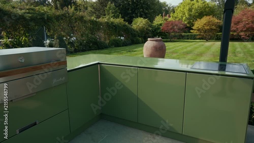 Modern green outdoor kitchen with a view of lush London garden