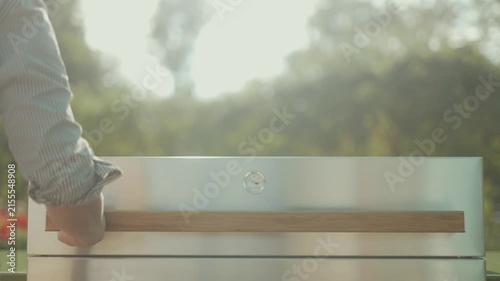 Close-up of modern outdoor kitchen drawer with wooden handle