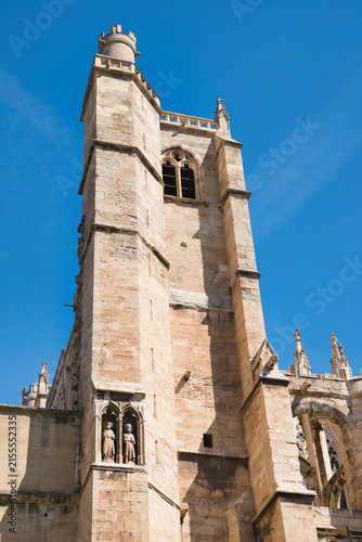 A close-up of the tower of the Cathedral of Saint Just et Saint Pasteur in Narbonne, a Gothic-style Catholic church located in Narbonne, France