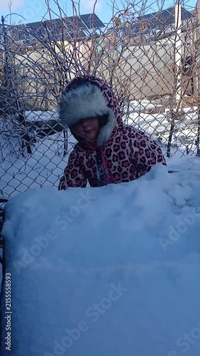 Child playing with snow in winter, part of a series