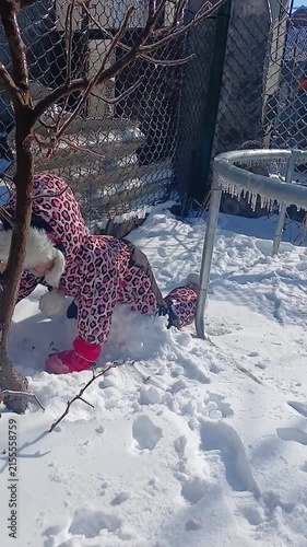 Child playing with snow in winter, part of a series