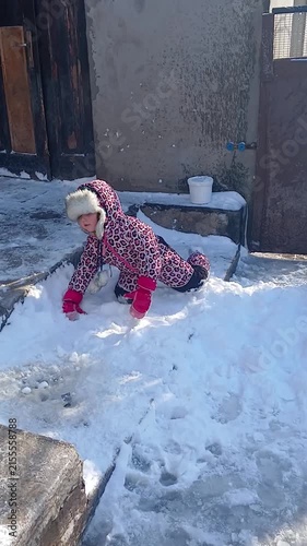 Child playing with snow in winter, part of a series