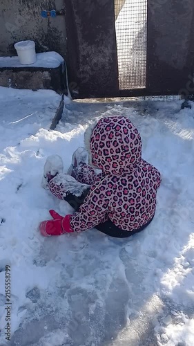 Child playing with snow in winter, part of a series