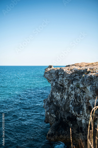 Beautiful seascape with rugged rocks, steep cliffs, and deep blue water
