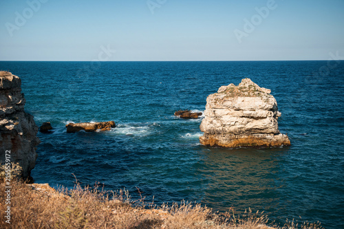 Beautiful seascape with rugged rocks, steep cliffs, and deep blue water