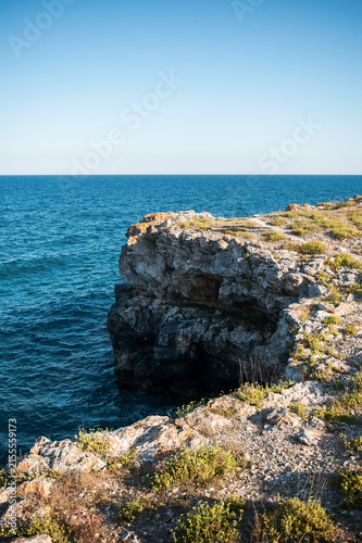 Beautiful seascape with rugged rocks, steep cliffs, and deep blue water