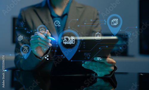 logistics operator using GPS radar and real-time fleet management dashboard on computer.