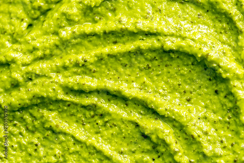 Green yogurt ice cream with pistachios, kiwi and avocado. Fresh fruit smoothie. Ice cream texture. Delicious sweet dessert close-up as background.