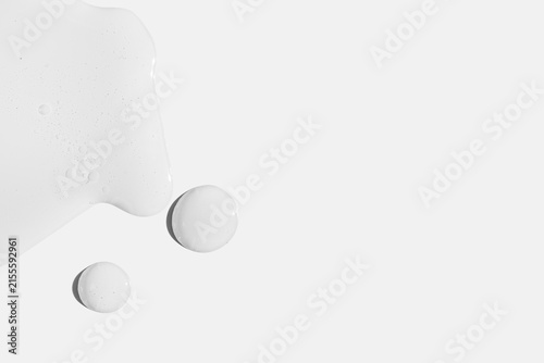 Clear Viscous Gel Drops and Spill on White Background with Copy Space