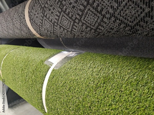 Rolls of carpet and artificial grass in a store display
