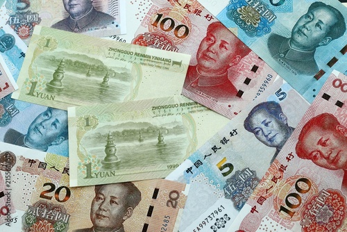 Chinese yuan money banknotes pile on table. China bills of CNY currency close up. Concept of economy