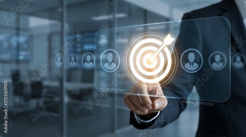Businessman touching a glowing digital target with an arrow in an office. Business strategy and marketing concept for.