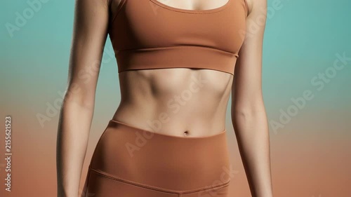 Close-up of woman fit abdomen and waist. Toned female belly in sportswear. Weight loss and fitness concept