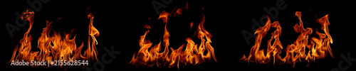 Obraz na plátně Dramatic orange flames isolated on a black background, creating a powerful fire texture for energy, heat, danger, destruction, lighting, backgrounds, and creative visual design