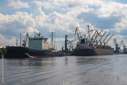 Large bulk carriers on the sea channel on Kanonersky Island. Transportation of various goods and products on cargo ships