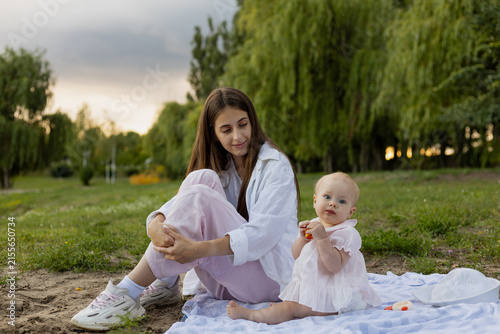 Konstfotografi Mother and baby enjoying a peaceful moment together on a blanket outdoors
