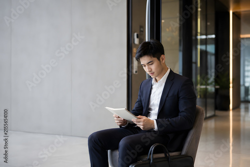 Businessman reviewing documents in modern office