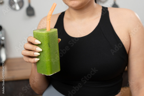 Woman drinking Green smoothie detox, or diet inspiration. vegan or fruit drink for nutrition