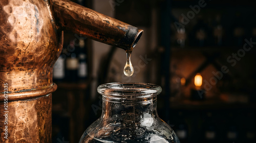 Traditional copper alembic distillation apparatus extracting pure essential oil drops