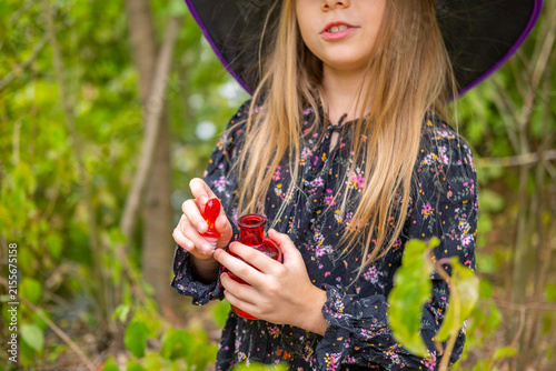 Картината върху платно girl in black witch hat holding red glass potion bottle with heart stopper, litt