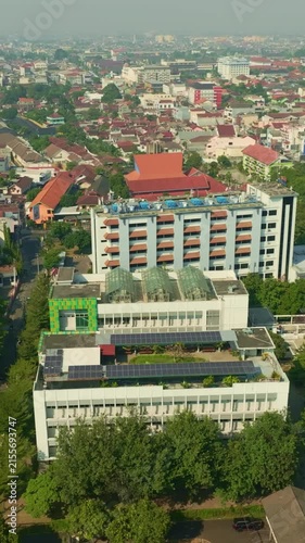 Urban building with rooftop solar panels across Yogyakarta skyline