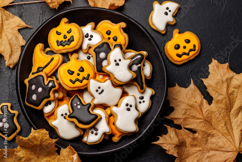 Halloween cookies on black stone background with copy space