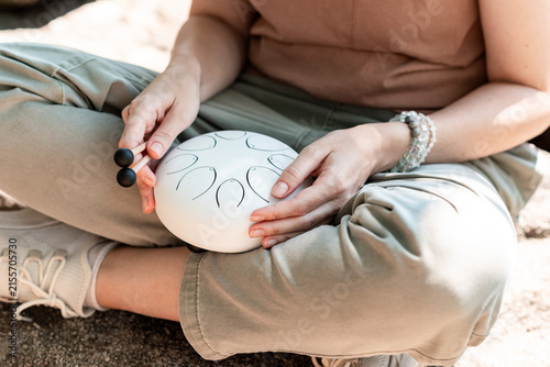 Woman Playing Steel Tongue Drum for Mindfulness and Relaxation