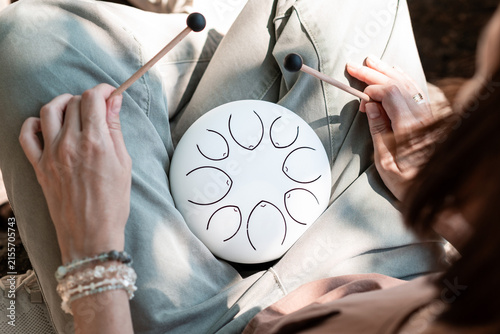 Woman Playing Steel Tongue Drum for Mindfulness and Relaxation