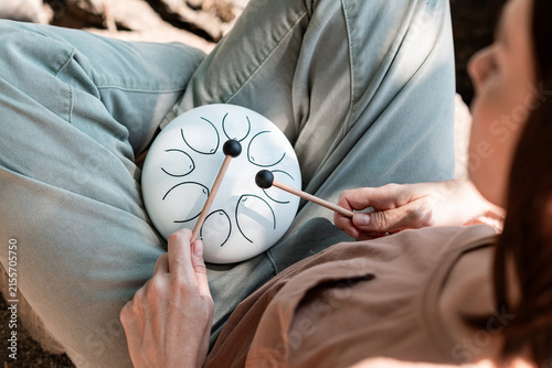 Woman Playing Steel Tongue Drum for Mindfulness and Relaxation