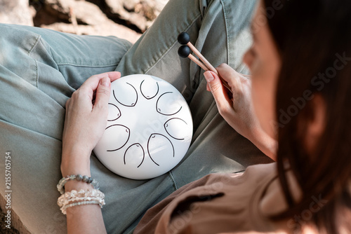 Woman Playing Steel Tongue Drum for Mindfulness and Relaxation