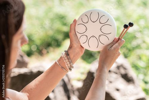Woman Playing Steel Tongue Drum for Mindfulness and Relaxation